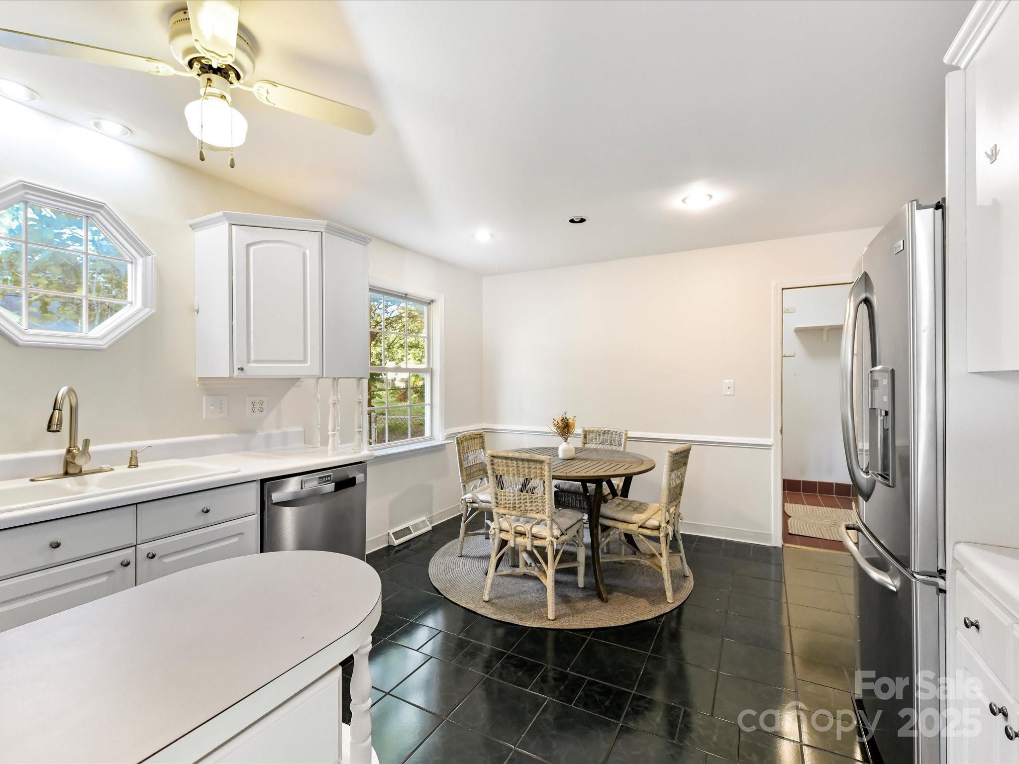 6313 Mill Grove Road Indian Trail, NC 28079 - Photo 21 of 47 a view of a dining room with furniture and a chandelier