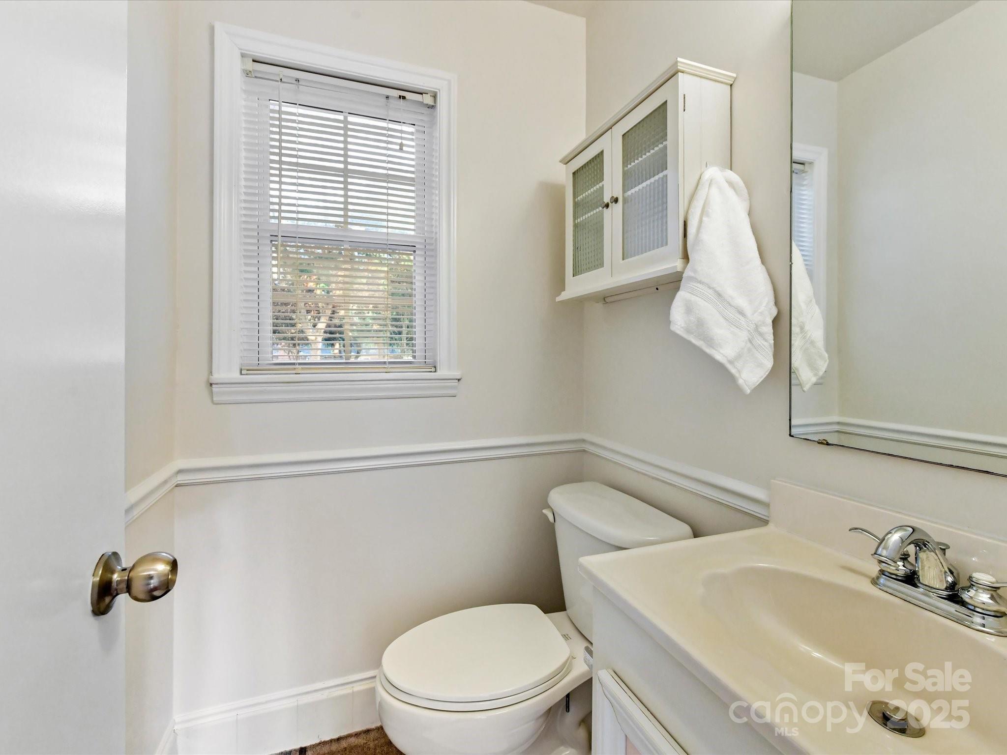 6313 Mill Grove Road Indian Trail, NC 28079 - Photo 24 of 47 a white toilet sitting next to a bathroom sink