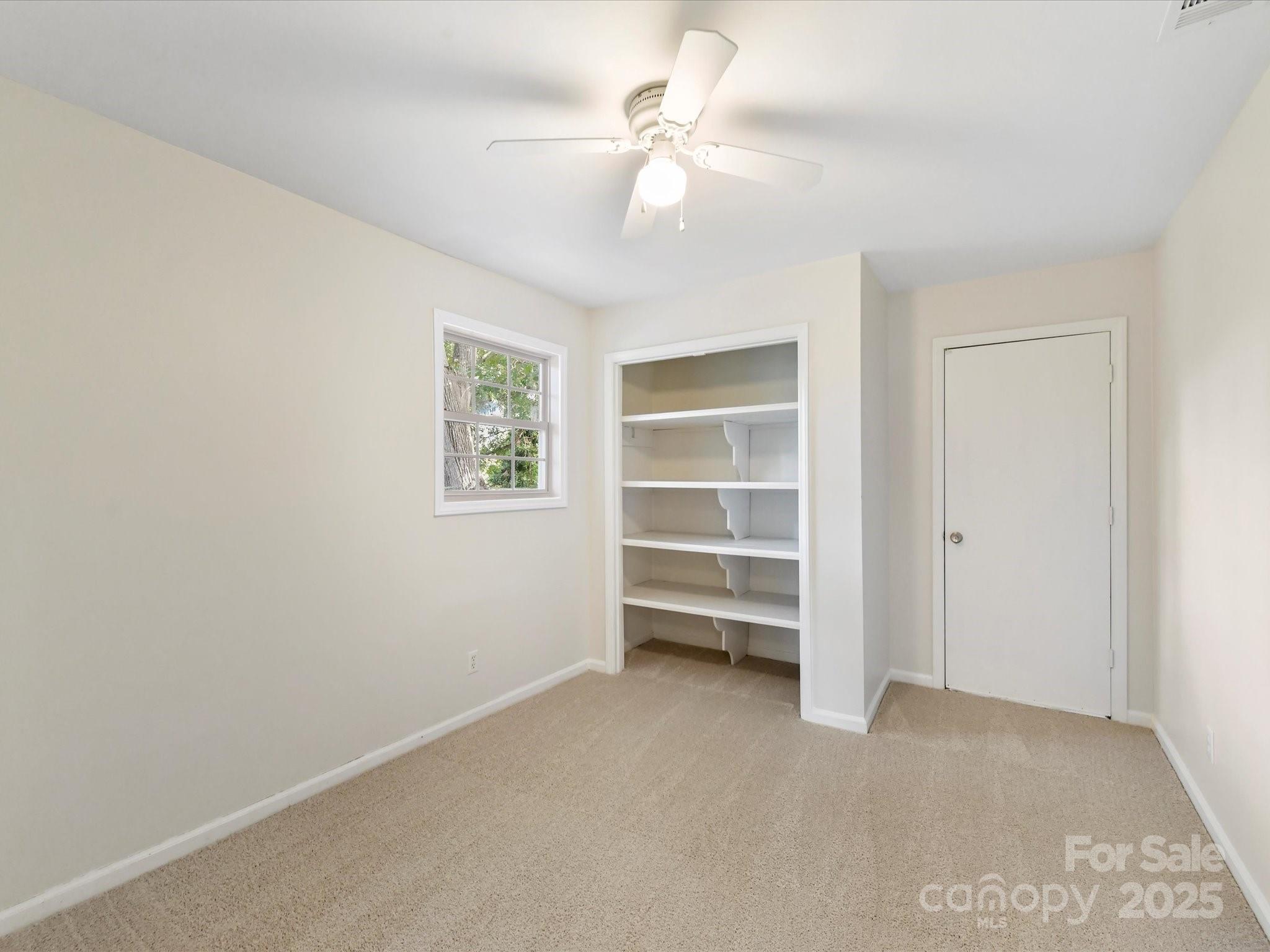 6313 Mill Grove Road Indian Trail, NC 28079 - Photo 31 of 47 an empty room with a ceiling fan and window