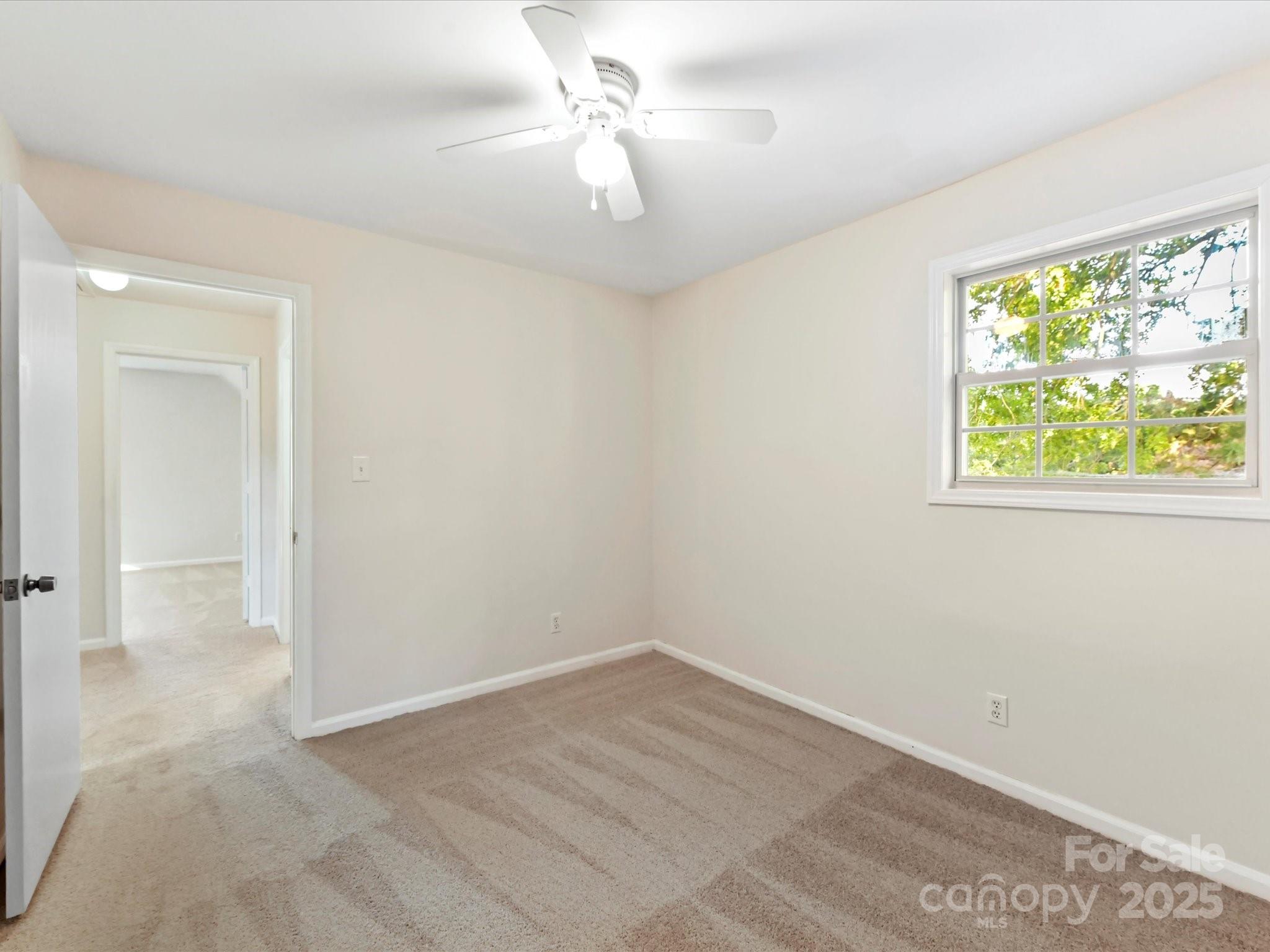 6313 Mill Grove Road Indian Trail, NC 28079 - Photo 32 of 47 an empty room with a window and a fan