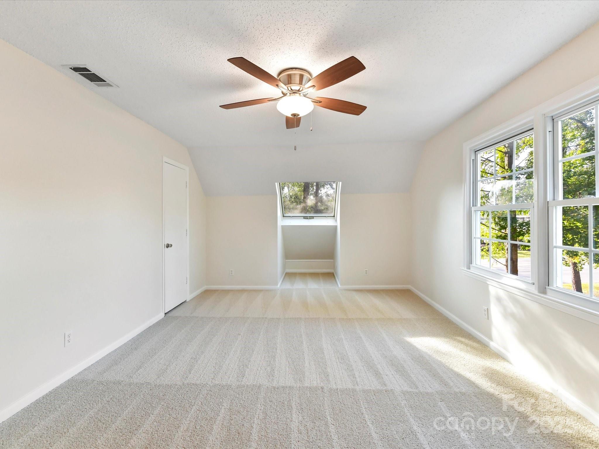 6313 Mill Grove Road Indian Trail, NC 28079 - Photo 34 of 47 an empty room with windows and ceiling fan