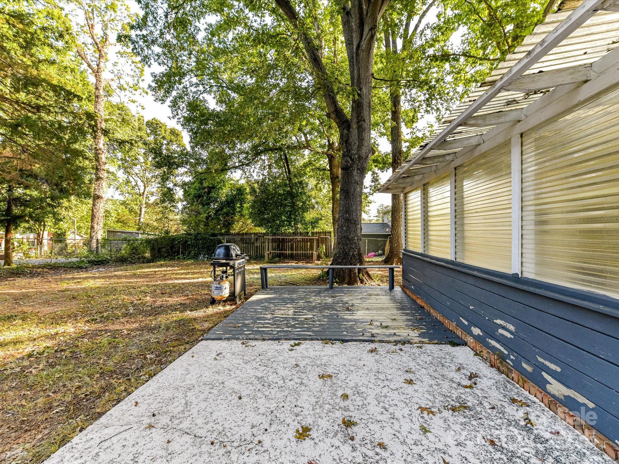 6313 Mill Grove Road Indian Trail, NC 28079 - Photo 43 of 47 a view of a backyard with wooden fence and large trees