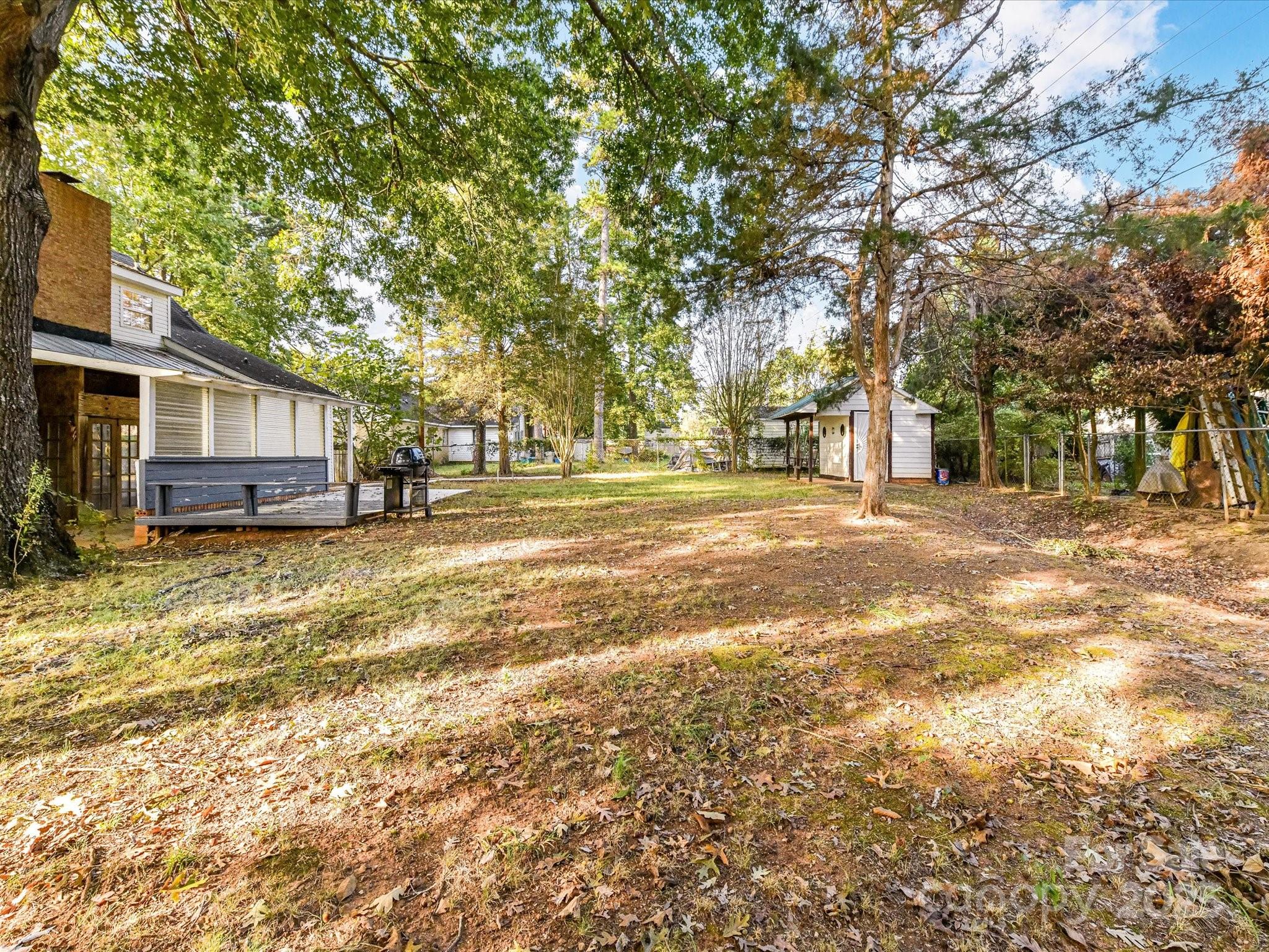 6313 Mill Grove Road Indian Trail, NC 28079 - Photo 44 of 47 a view of a yard with a house and trees in the background