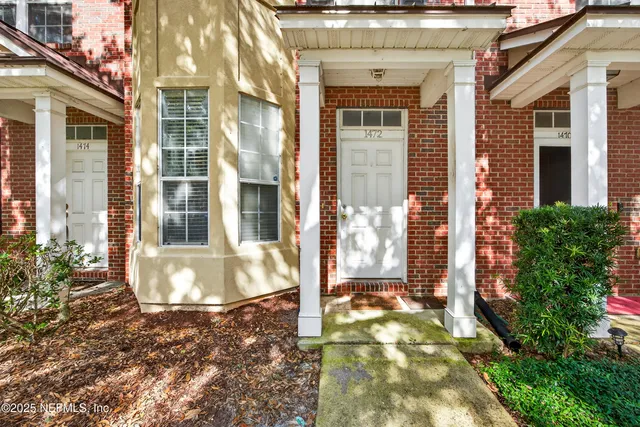 a view of a brick house with a large windows