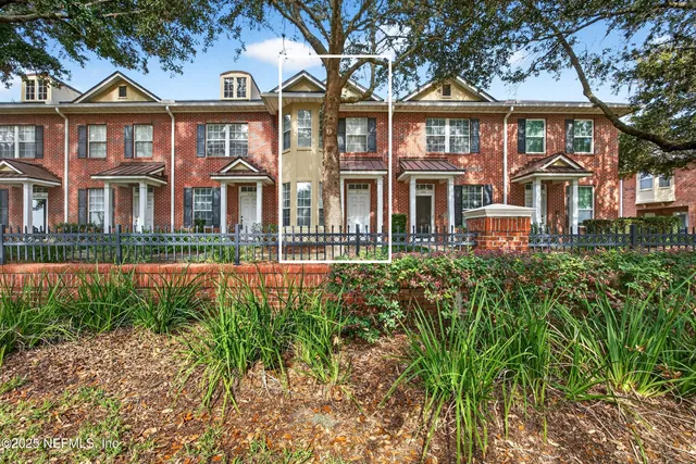 a front view of a residential apartment building with a yard