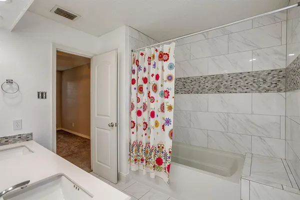 a bathroom with a bathtub and shower