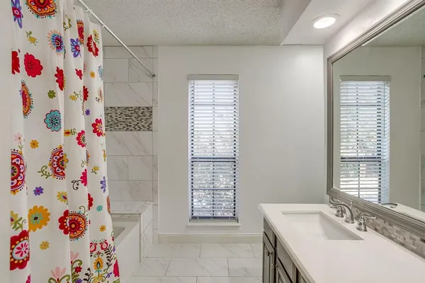 a bathroom with a sink and a shower