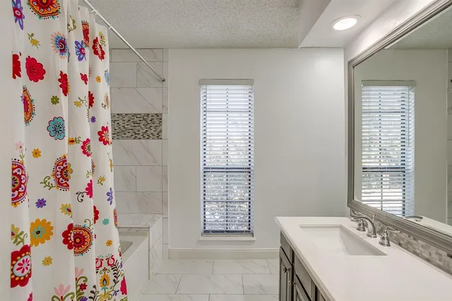 a bathroom with a sink and a shower