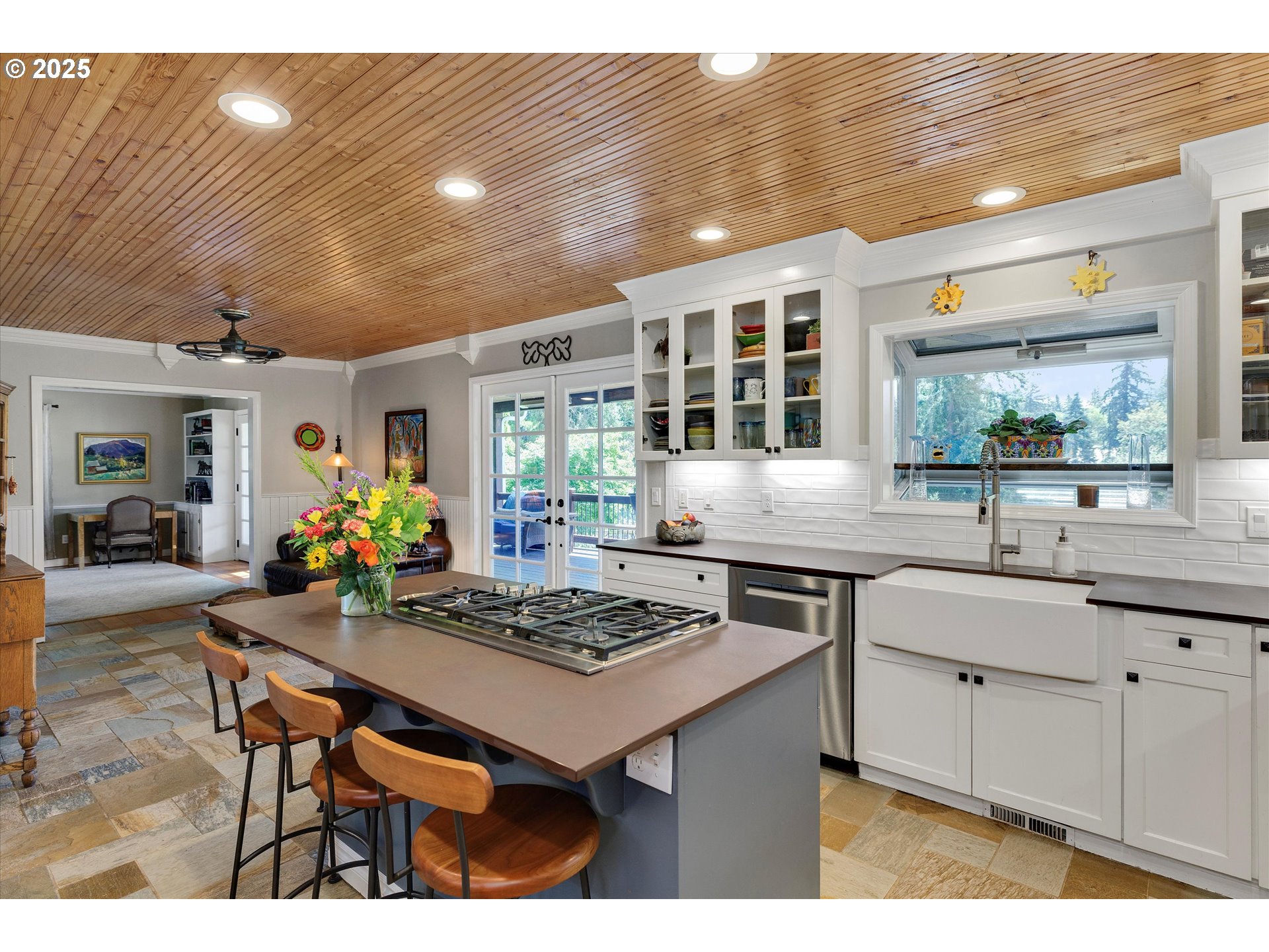 11800 South Carus Road Canby, OR 97013 - Photo 12 of 45 a kitchen with a stove a sink dishwasher and a dining table with chairs