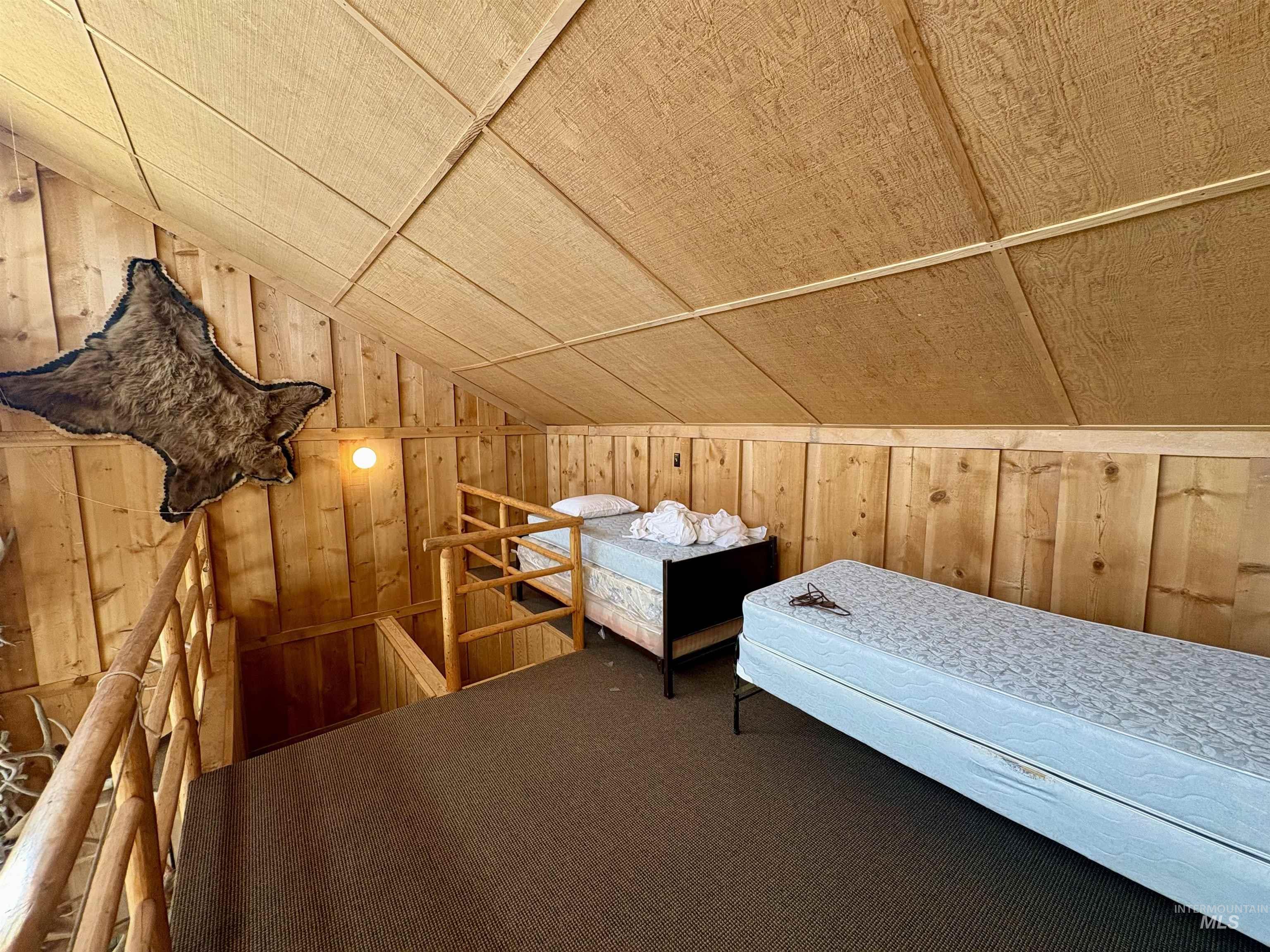 2040 Pahsimeroi River Road May, ID 83253 - Photo 20 of 29 Wood-paneled room with sloped ceilings and carpeted flooring