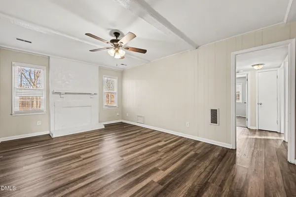 wooden floor in an empty room with a window