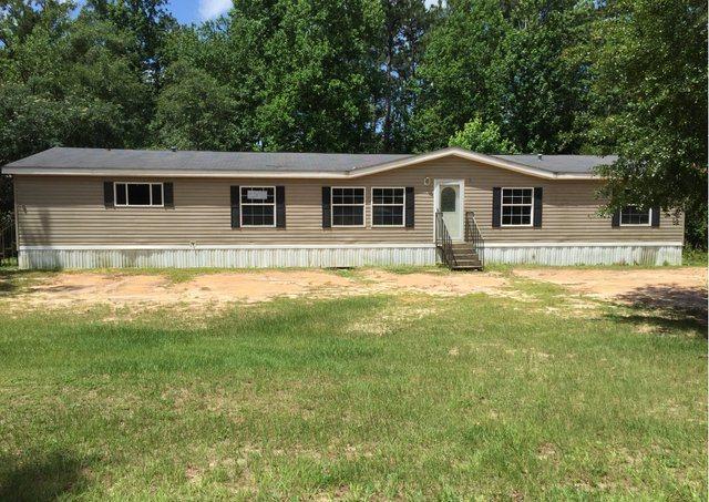 1054 Reeves Road Baker, FL 32531 - Photo 1 of 14 a view of a house with a yard
