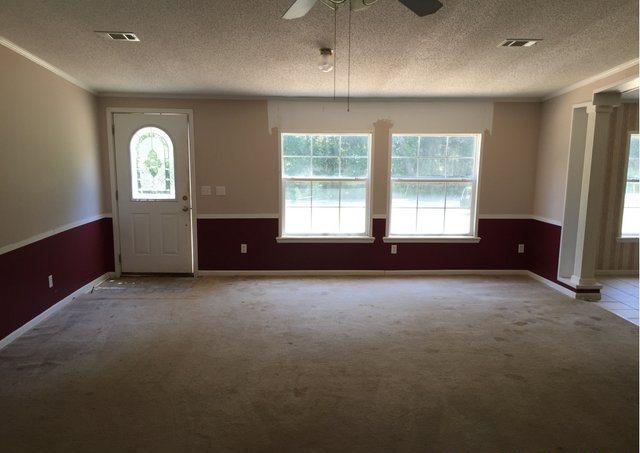 1054 Reeves Road Baker, FL 32531 - Photo 2 of 14 a view of an empty room with a window and a kitchen