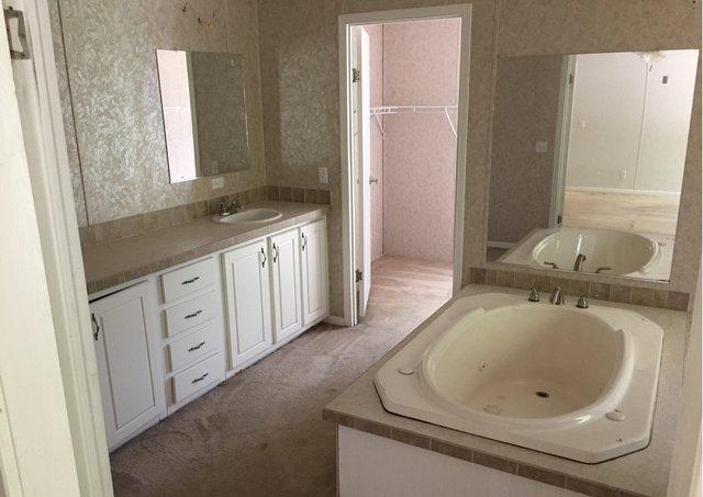 1054 Reeves Road Baker, FL 32531 - Photo 8 of 14 a bathroom with a granite countertop sink and a mirror