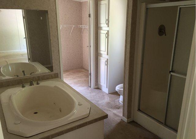 1054 Reeves Road Baker, FL 32531 - Photo 9 of 14 a bathroom with a tub and sink