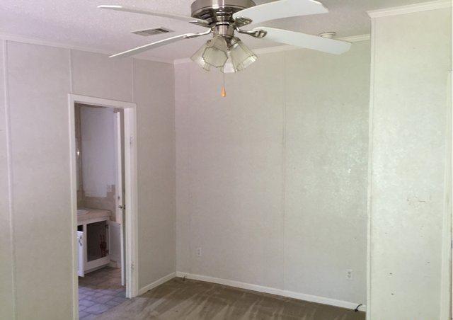 1054 Reeves Road Baker, FL 32531 - Photo 10 of 14 a view of a hallway with a chandelier fan