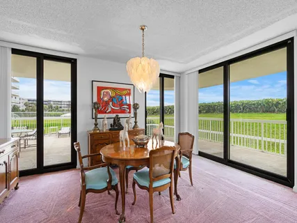 a dining room with furniture a chandelier and pool table