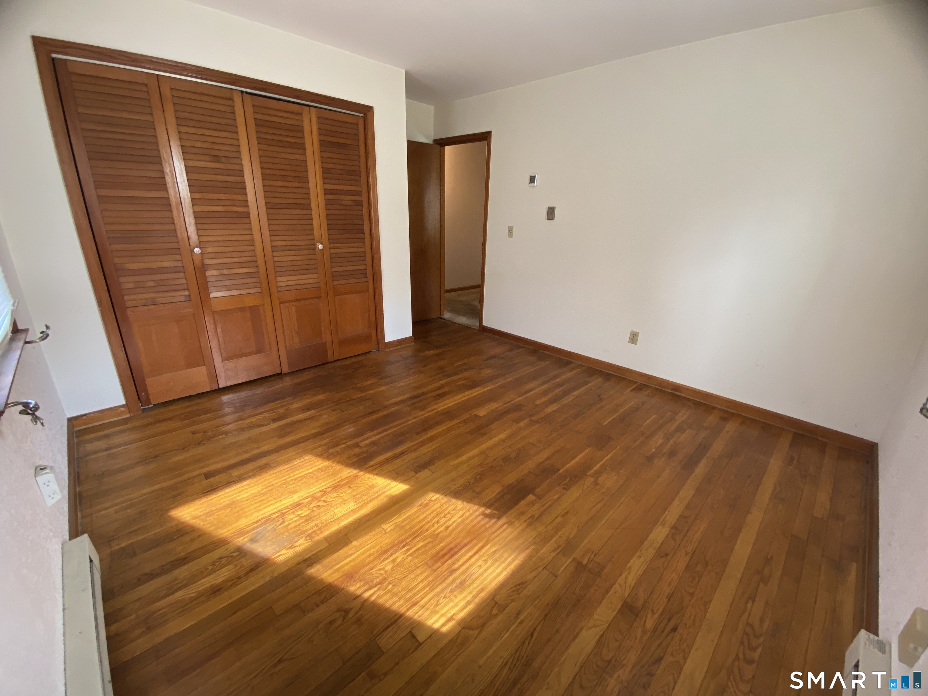 268 Bell Street Middletown, CT 06457 - Photo 12 of 36 a view of an empty room with wooden floor and a window