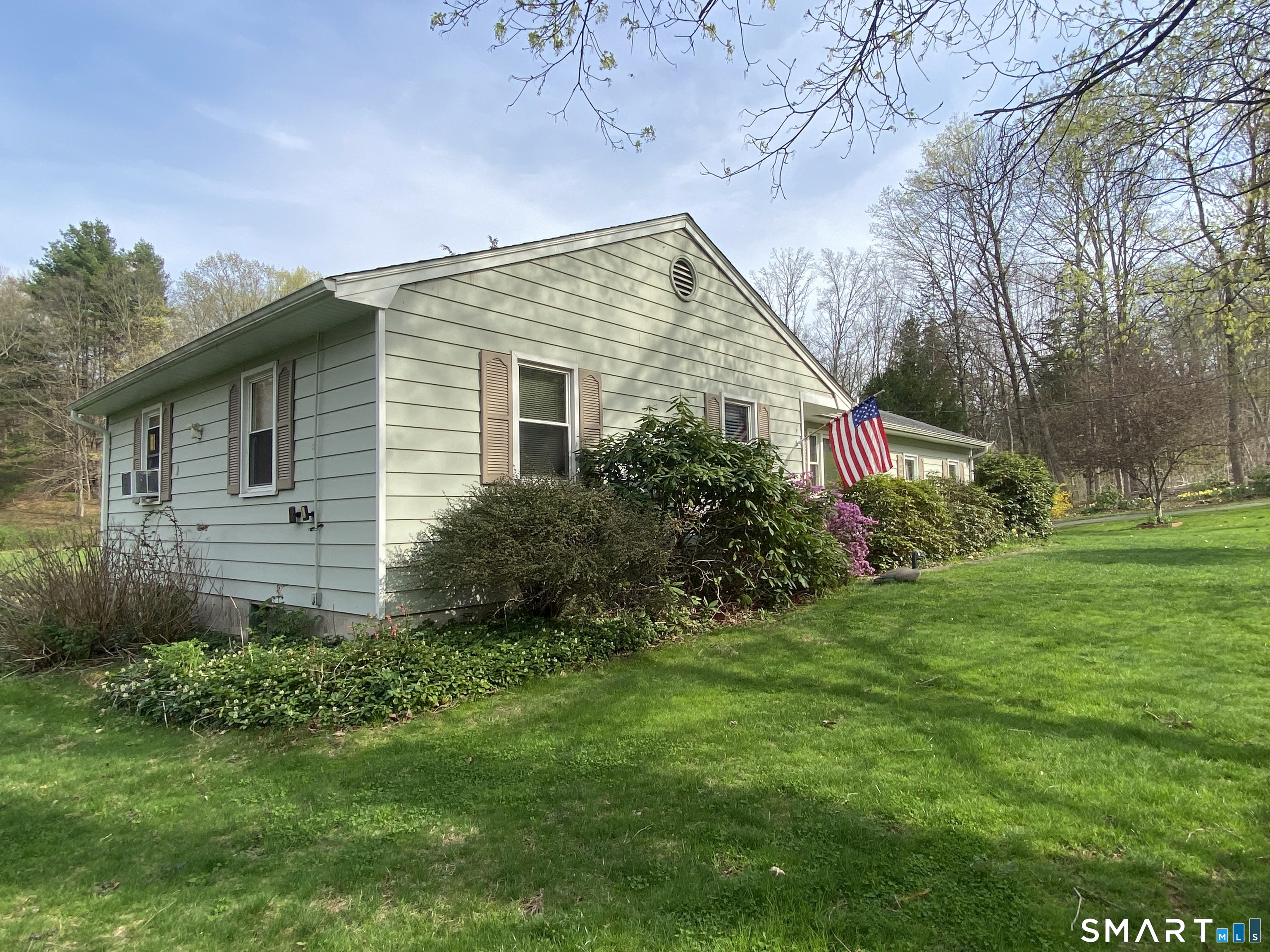268 Bell Street Middletown, CT 06457 - Photo 23 of 36 a backyard of a house with plants and large tree