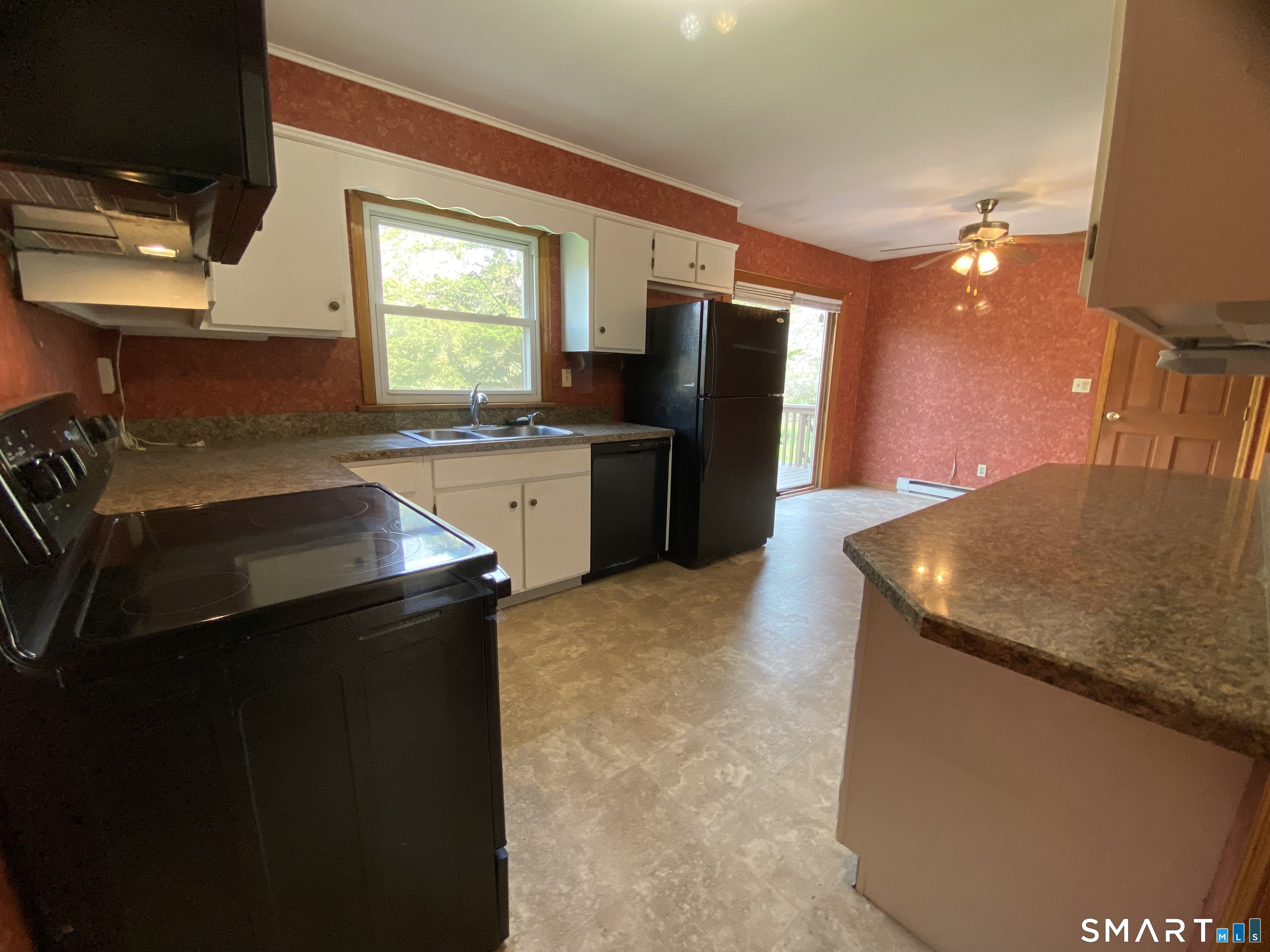 268 Bell Street Middletown, CT 06457 - Photo 5 of 36 a kitchen with a sink a kitchen island and stainless steel appliances