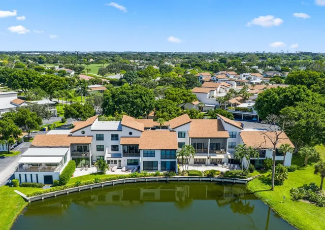 a aerial view of a house with a garden and lake view