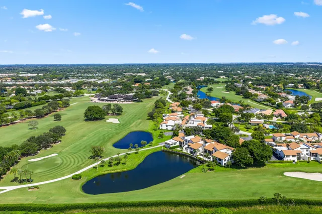 an aerial view of a residential houses with outdoor space and street view