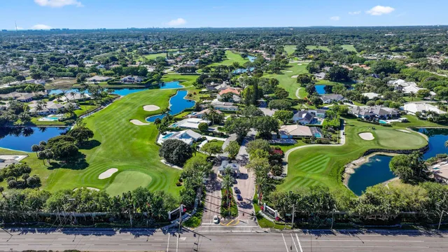 an aerial view of a residential houses with outdoor space and street view
