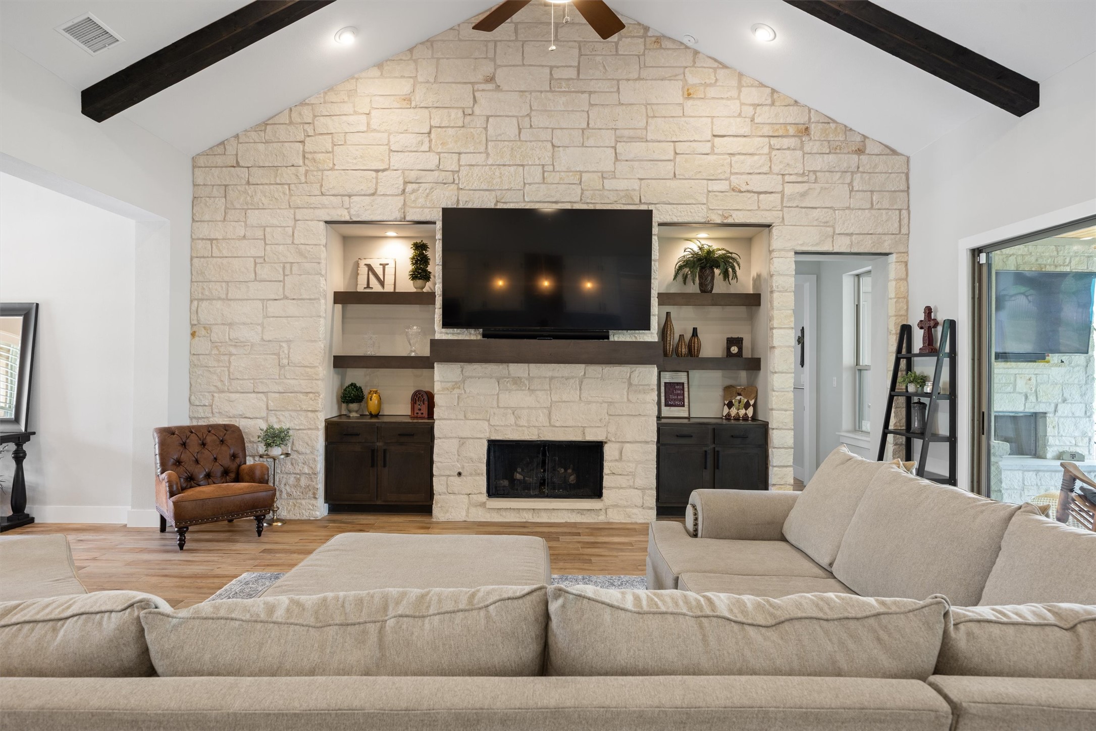 2009 Nature View Loop Driftwood, TX 78619 - Photo 4 of 37 a living room with furniture a flat screen tv and a fireplace