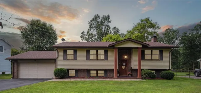 a view of a house with wooden walls and a yard