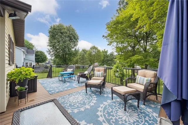 a view of a patio with a dining table and chairs with wooden floor
