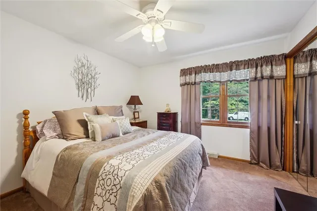a bedroom with a large bed and a chandelier