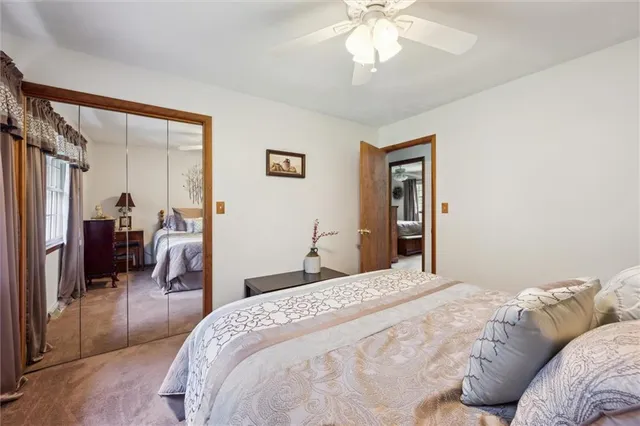 a bedroom with a large bed and a chandelier