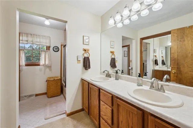 a bathroom with a sink double vanity and a mirror