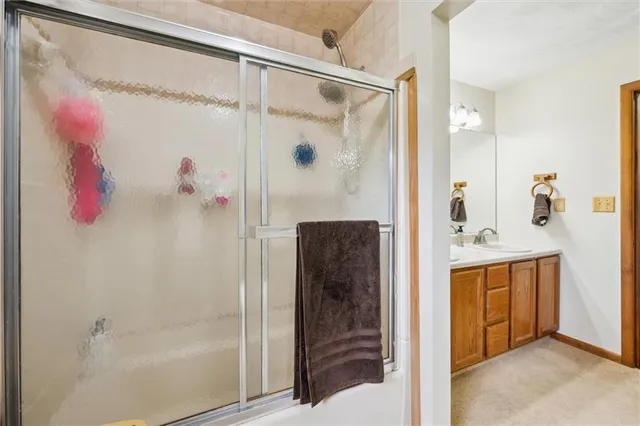 a bathroom with a shower and a sink