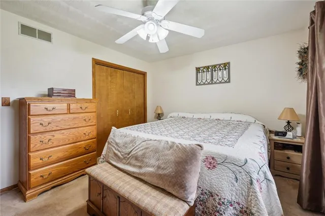 a bedroom with a dresser and a chandelier
