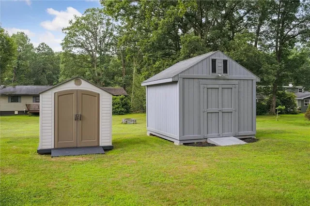 a view of a house with a yard and sitting area