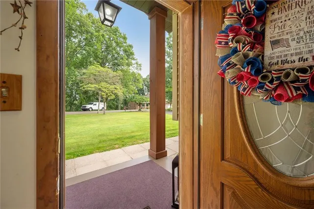 a view of a floor to ceiling window and a tree