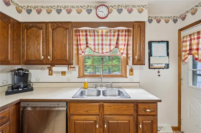 a kitchen with a sink a stove and a microwave