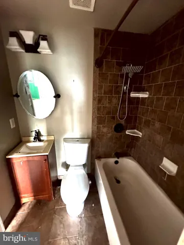 a bathroom with a sink mirror vanity and toilet