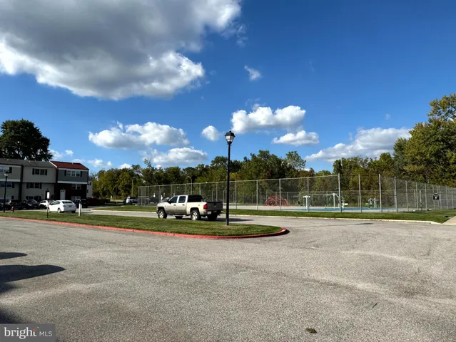 a view of a playground ground and trees