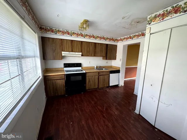 a kitchen with stainless steel appliances granite countertop wooden floors and sink