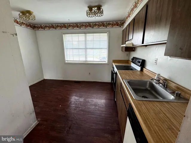 a kitchen with a wooden floor and a stove