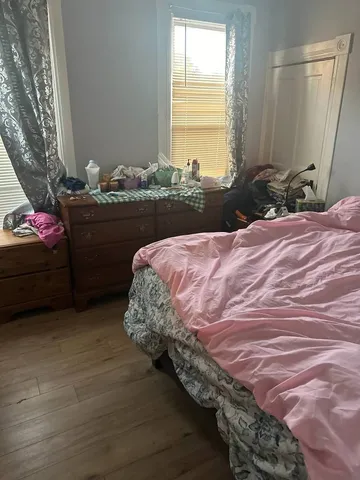 a bedroom with a bed and a window
