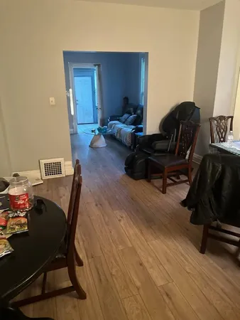 a living room with furniture and wooden floor