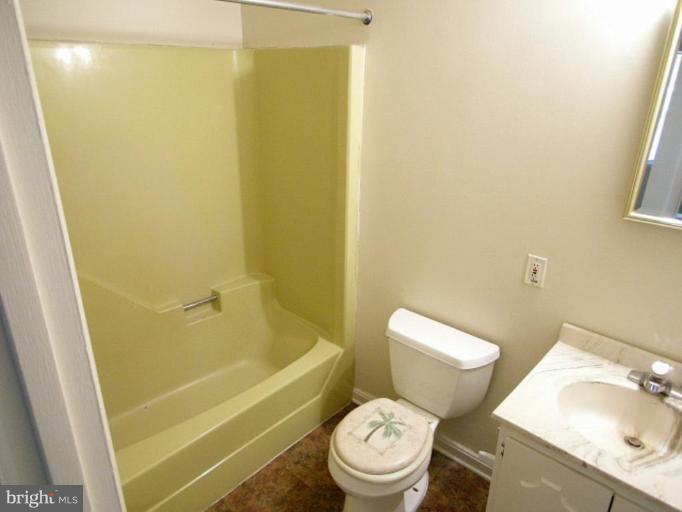 313 Deale Road Tracys Landing, MD 20779 - Photo 14 of 15 a white toilet sitting next to a bath tub