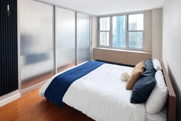 a bedroom with a bed and a window