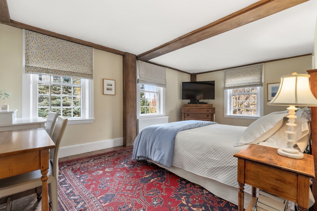 221 Boston Post Road Wayland, MA 01778 - Photo 13 of 37 a bedroom with a bed and wooden floor