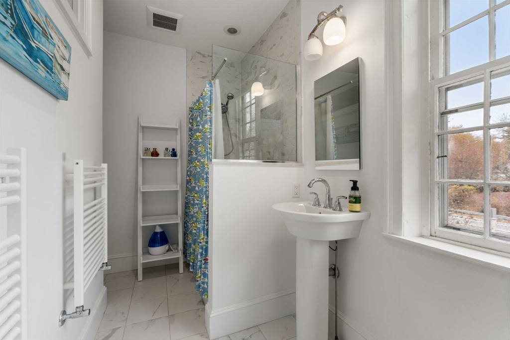 221 Boston Post Road Wayland, MA 01778 - Photo 24 of 37 a bathroom with a sink a mirror and a shower