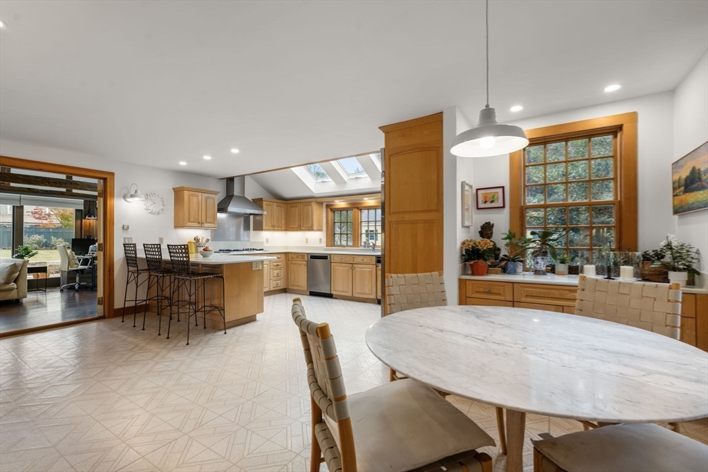 221 Boston Post Road Wayland, MA 01778 - Photo 27 of 37 a dining hall with stainless steel appliances kitchen island granite countertop a dining table chairs and view of living room