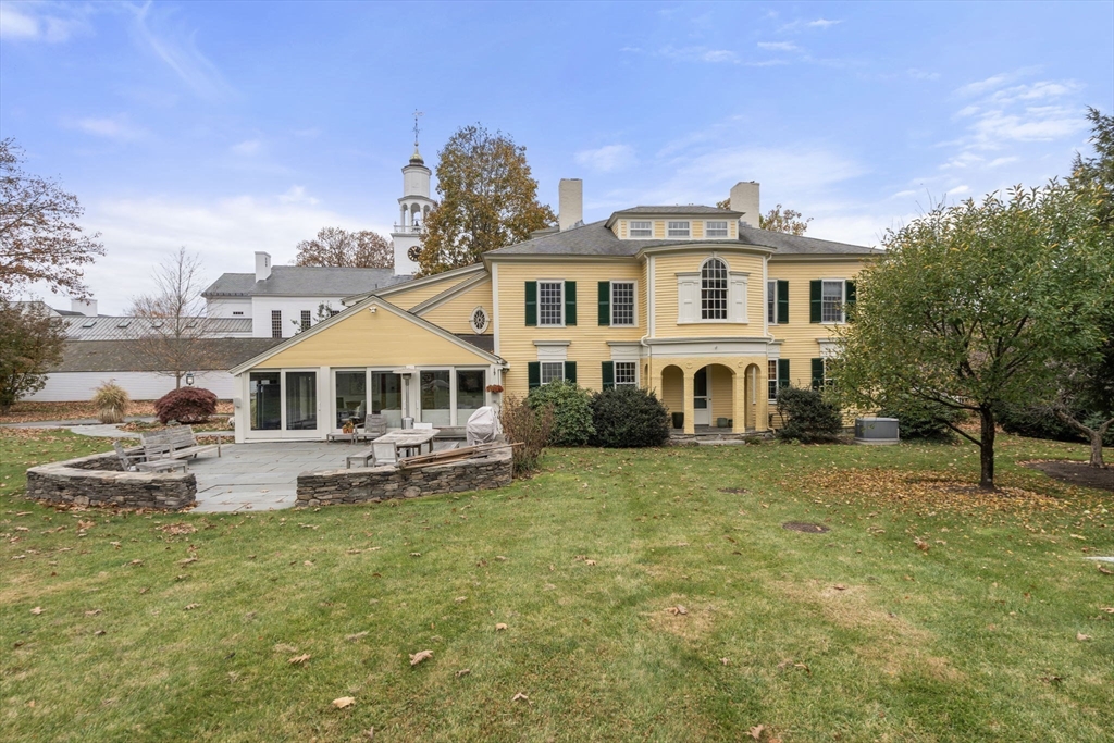 221 Boston Post Road Wayland, MA 01778 - Photo 28 of 37 a front view of a house with a yard table and chairs